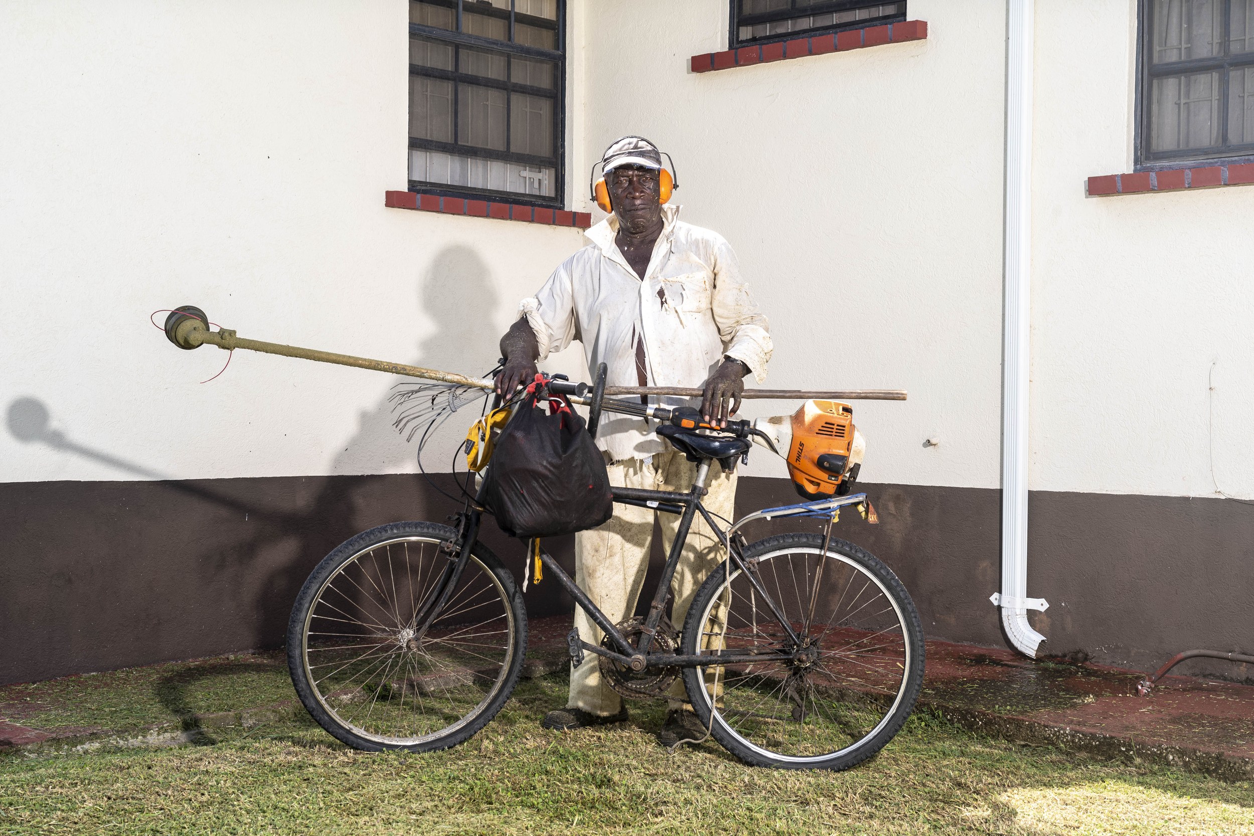 Sweet Boy with a bicycle and landscaping equipment in Barbados