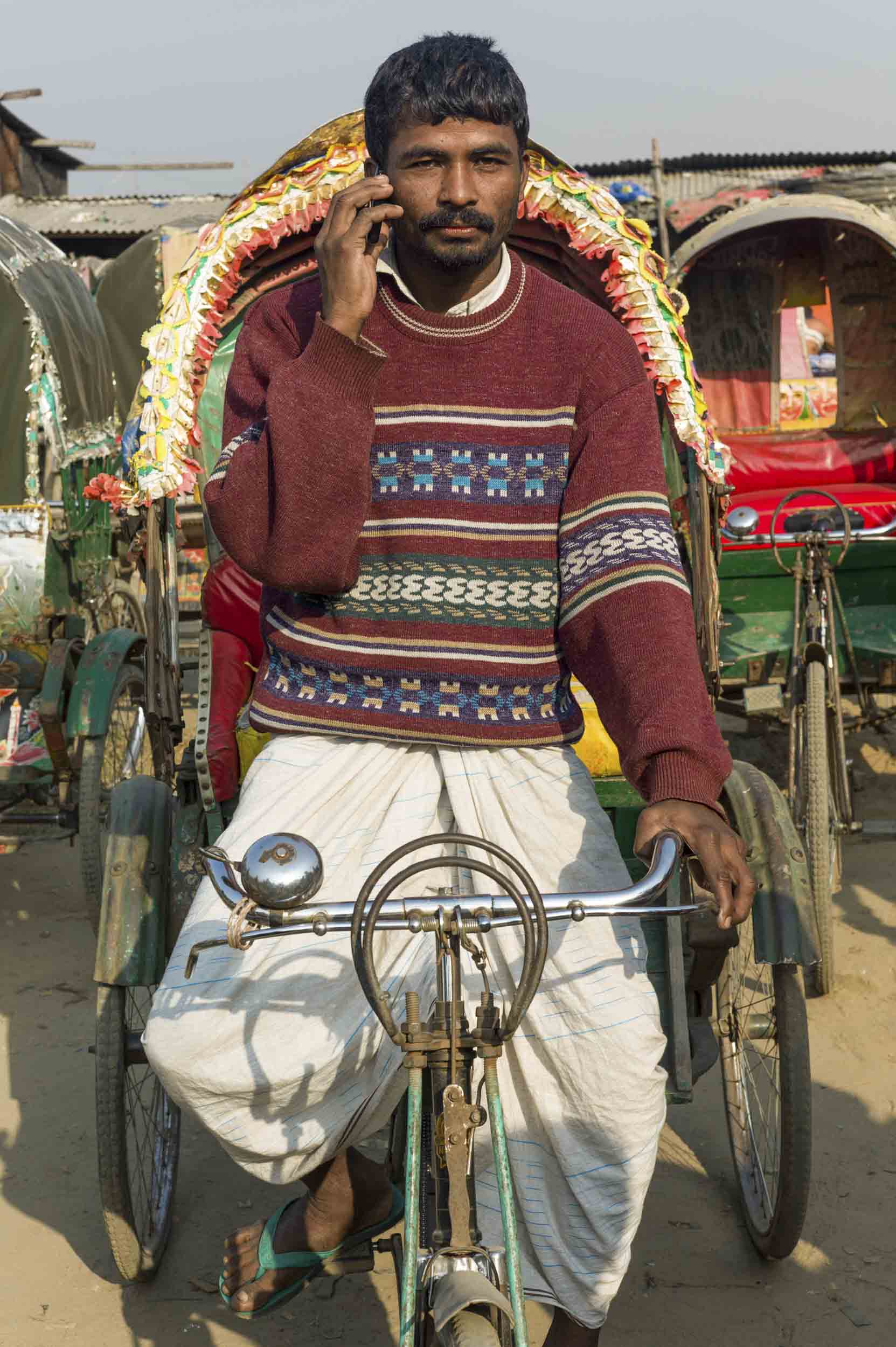 A rickshaw driver at his livery in a Dhaka slum, 2012