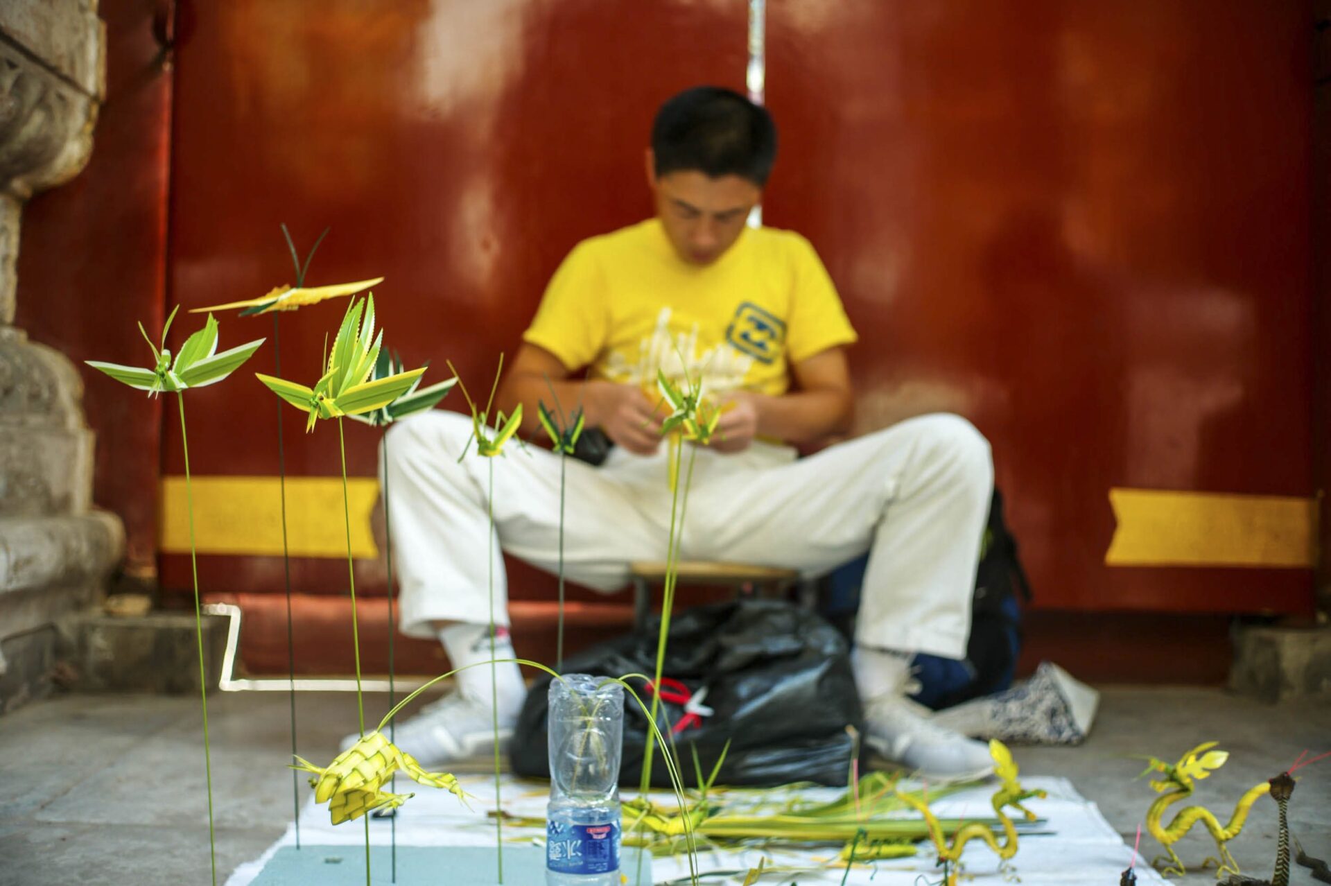 An artisan folds origami creatures outside the Summer Palace’s Sea of Wisdom Temple, Beijing, 2011