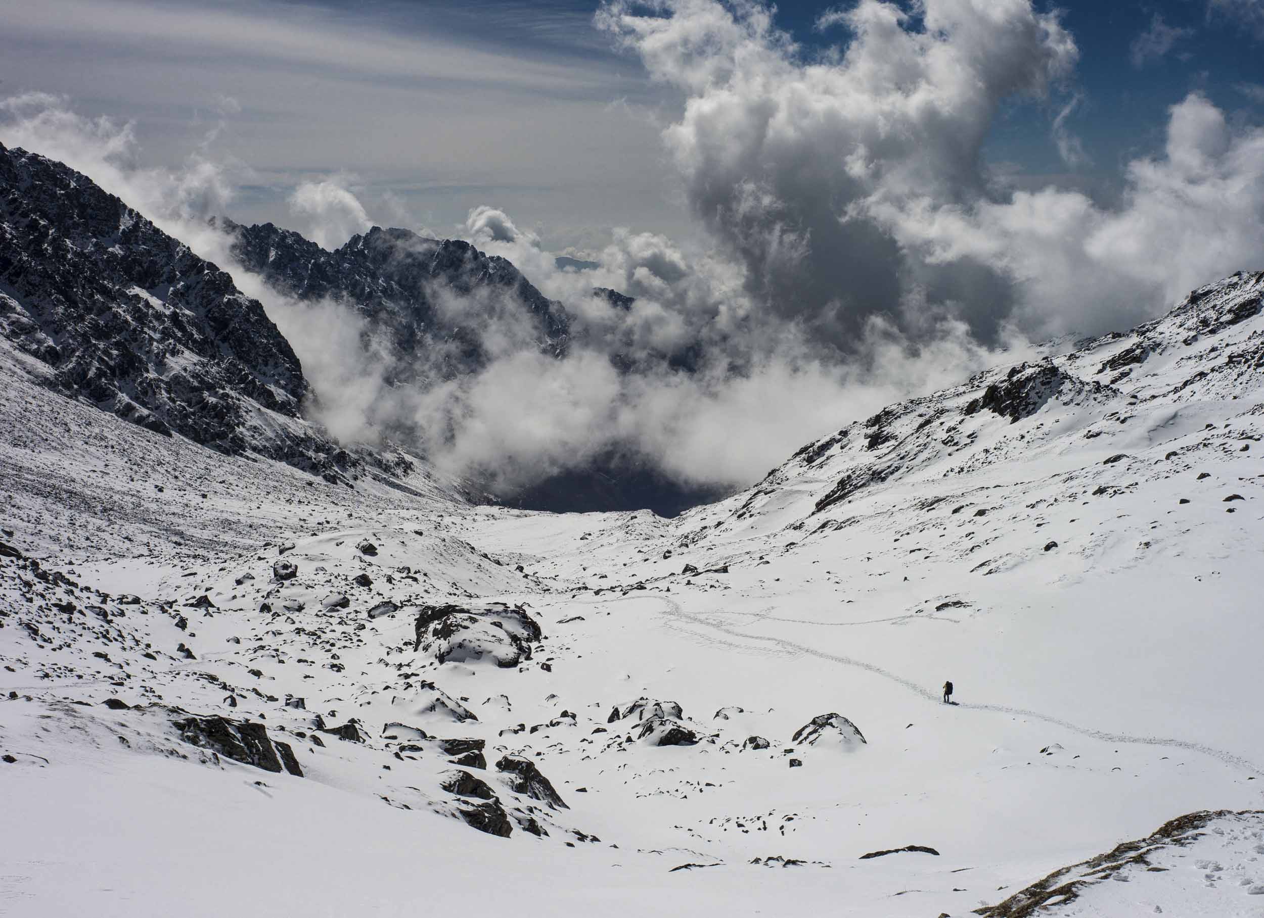 Clouds seem to flow up the snowy mountainside along the Gosain Kund to Ghopte portion of the trail