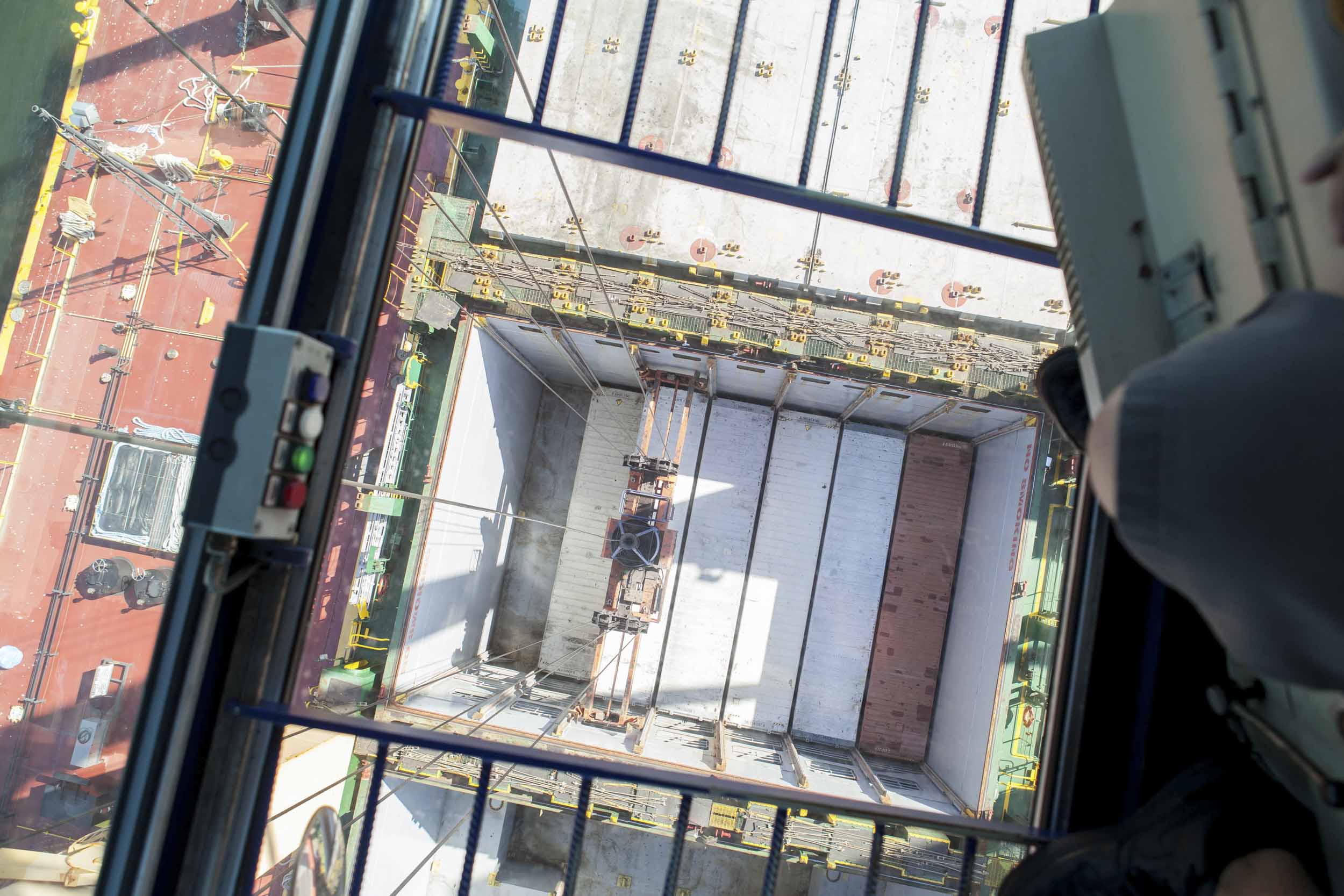 A birds-eye view of a container ship’s hold from the crane’s 100-foot high cockpit